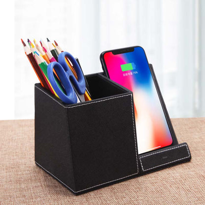 leather pen holder wireless charger with pens and scissors next to a smartphone on a table