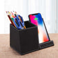 leather pen holder wireless charger with pens and scissors next to a smartphone on a table